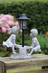 Solar Garden Stone Effect Ornament Boy and Girl playing on a Seesaw