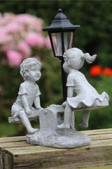 Solar Garden Stone Effect Ornament Boy and Girl playing on a Seesaw