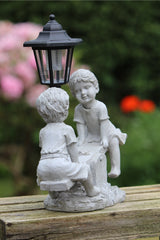 Solar Garden Stone Effect Ornament Boy and Girl playing on a Seesaw