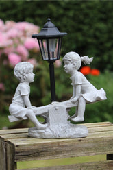 Solar Garden Stone Effect Ornament Boy and Girl playing on a Seesaw