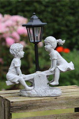 Solar Garden Stone Effect Ornament Boy and Girl playing on a Seesaw
