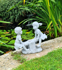 Garden Ornament Boy and Girl playing on a Seesaw