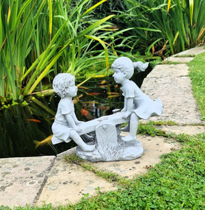 Garden Ornament Boy and Girl playing on a Seesaw