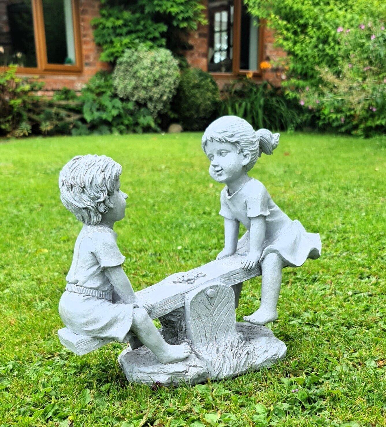 Garden Ornament Boy and Girl playing on a Seesaw