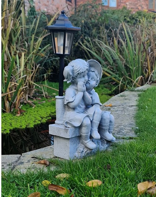 Solar Garden Ornament Boy and Girl Kissing on a Bench